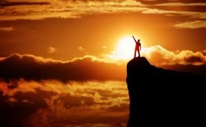 Boy standing top of the hill
