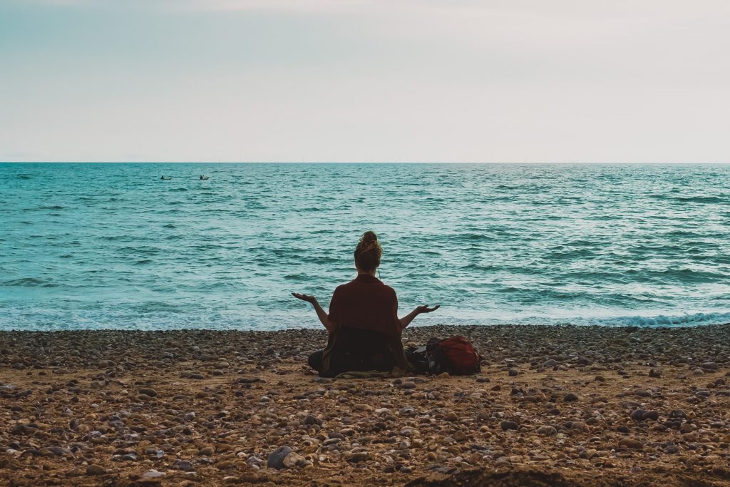 Woman meditating at beach