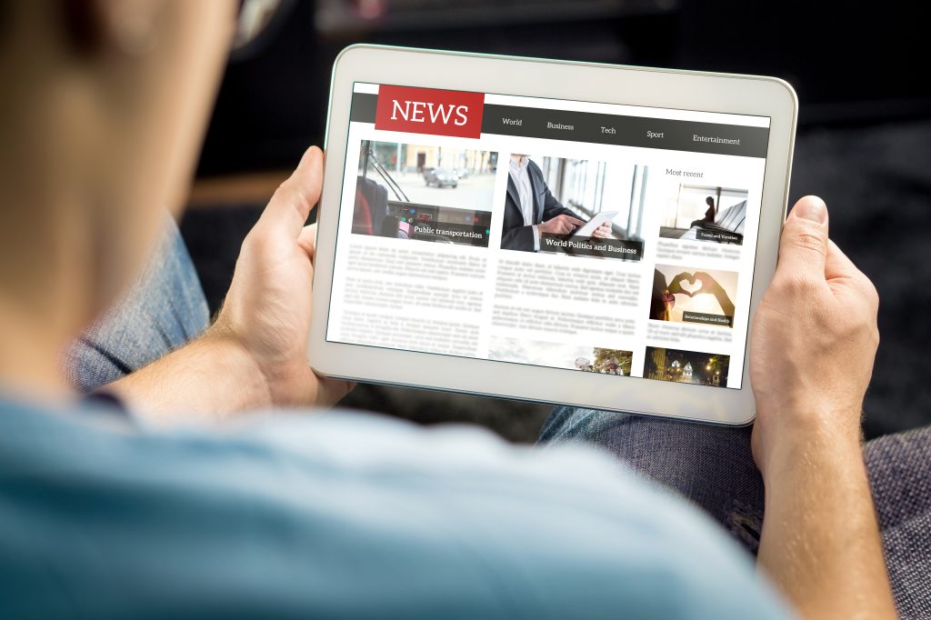 Man reading news on tab