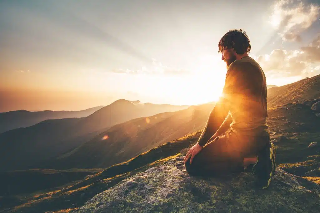 Boy on mountain at sunset